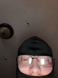 a person wearing a ninja mask and glasses